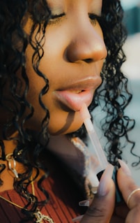 a close up of a person holding a toothbrush