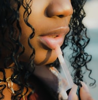 a close up of a person holding a toothbrush