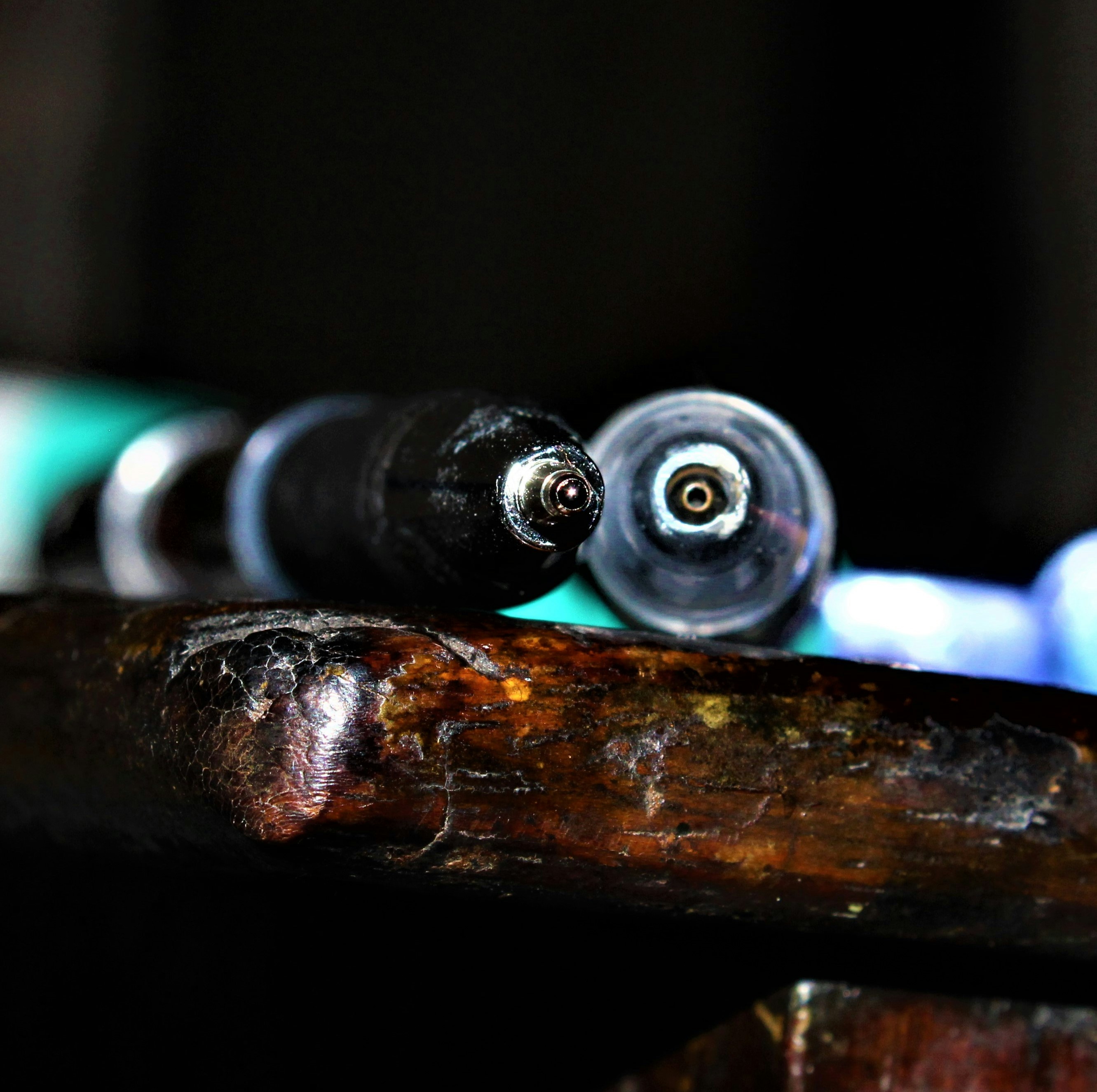 Close-up detail of precision pen barrel and nib, neutral warm background, professional product photography
