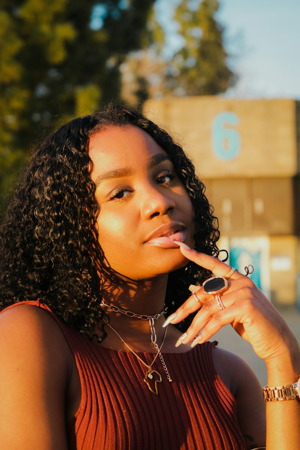 a woman smoking a cigarette in front of a building