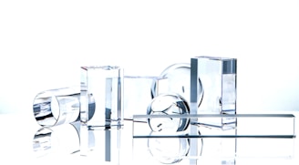 A collection of precision-cut optical glass elements arranged neatly on a clean surface.