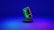 A smartphone displaying green computer code stands upright on a round, dark platform. The background fades from deep blue at the top to purple at the bottom, creating a futuristic and digital ambiance.
