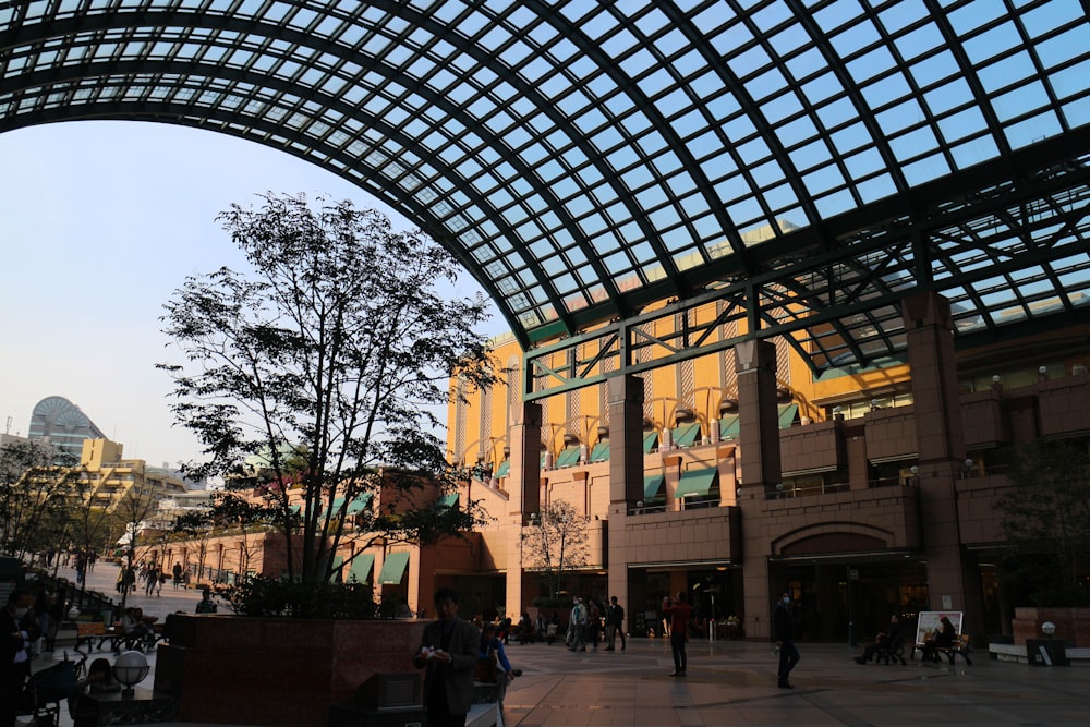 a group of people walking around a building