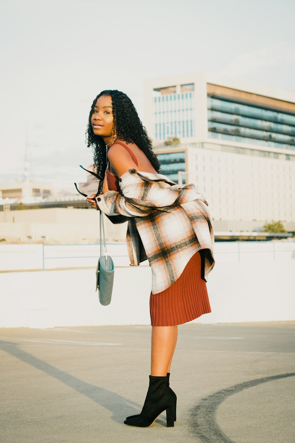 a woman in a plaid shirt and skirt