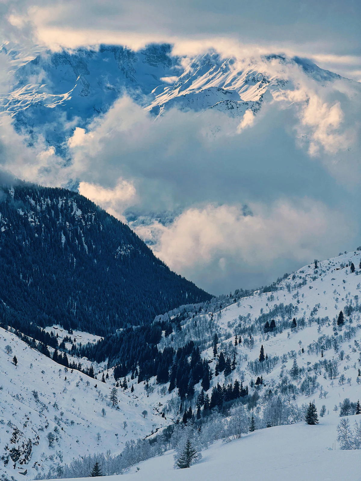 Mountain covered in snow with clouds