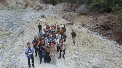 A group photo of smiling Crimson Nexus members gathered outdoors with red rock formations behind them.