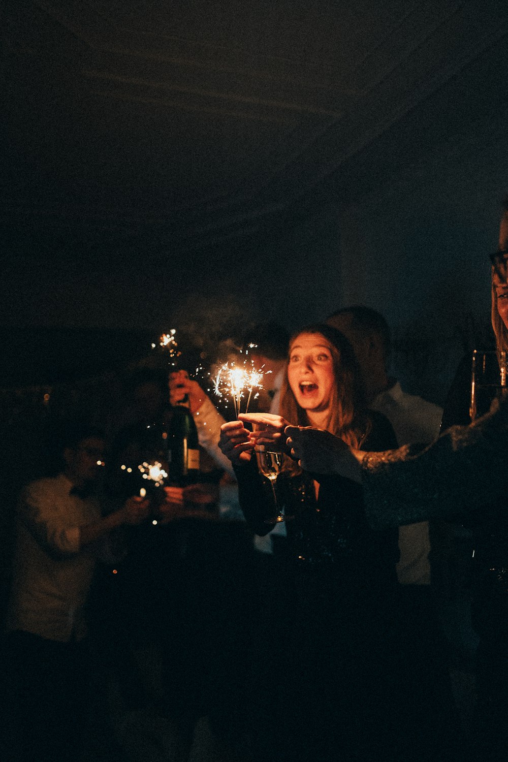 a group of people holding sparklers in their hands