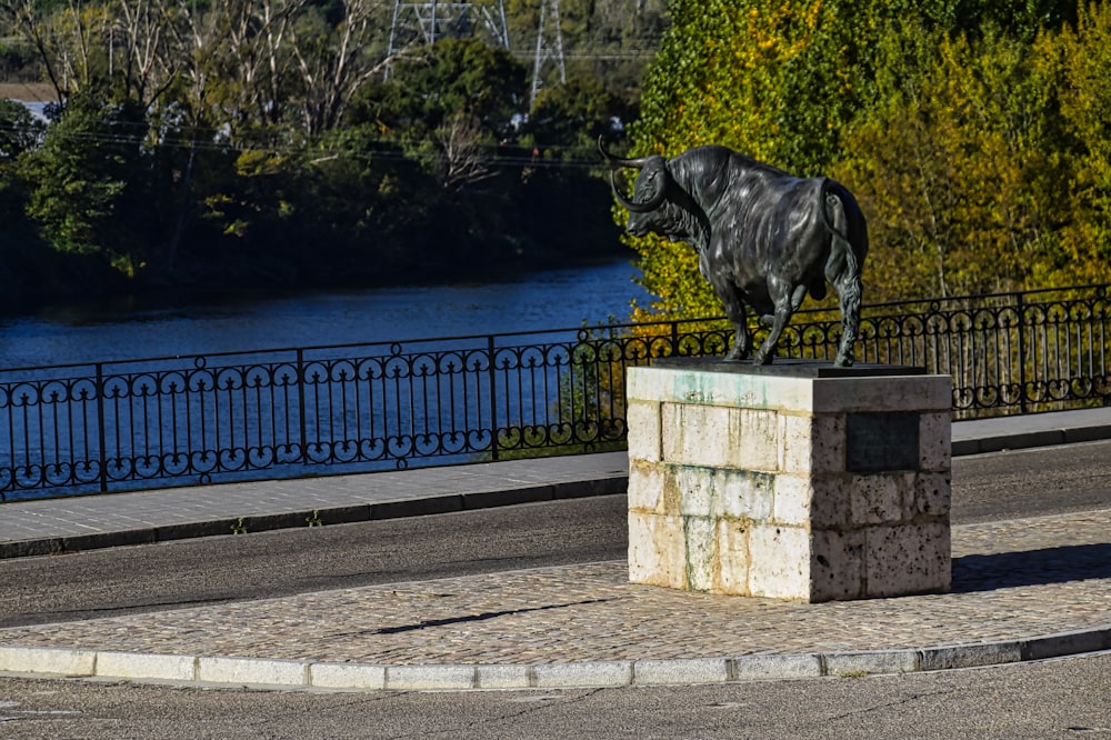 a statue of a horse on a pedestal in a park