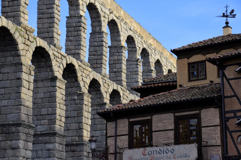 a large stone bridge over a river next to a tall building