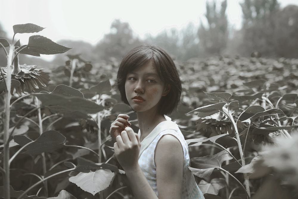 a woman standing in a field of sunflowers