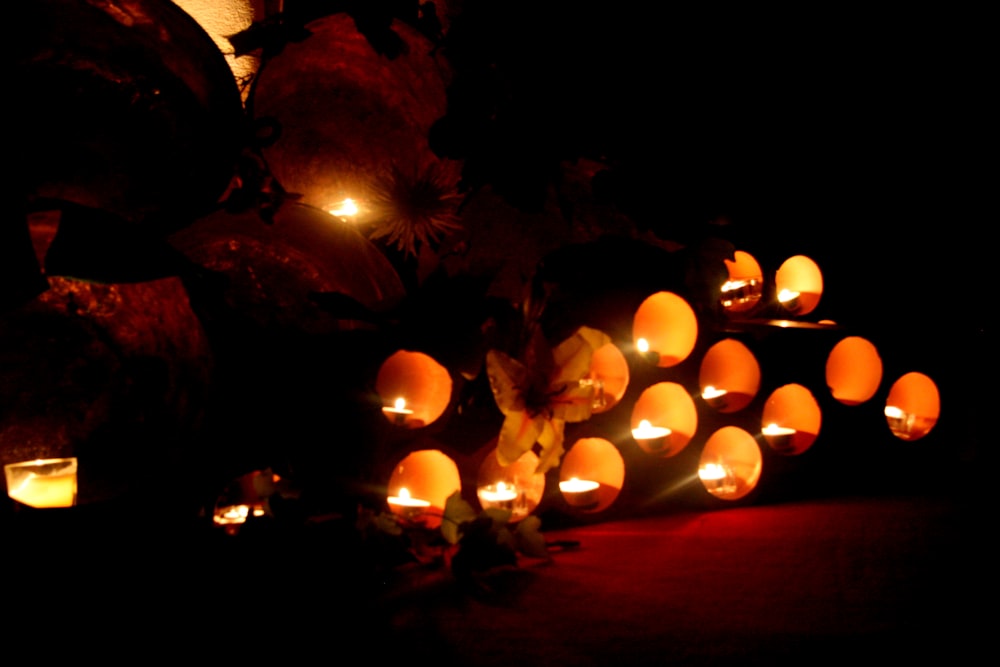 a bunch of pumpkins that are lit up in the dark