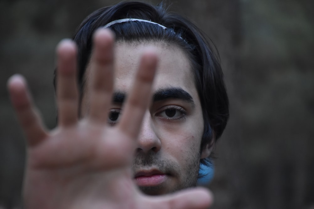 a man making a hand gesture with his fingers