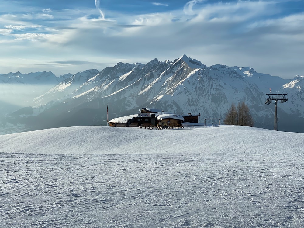 a snow covered mountain with a ski lift in the background