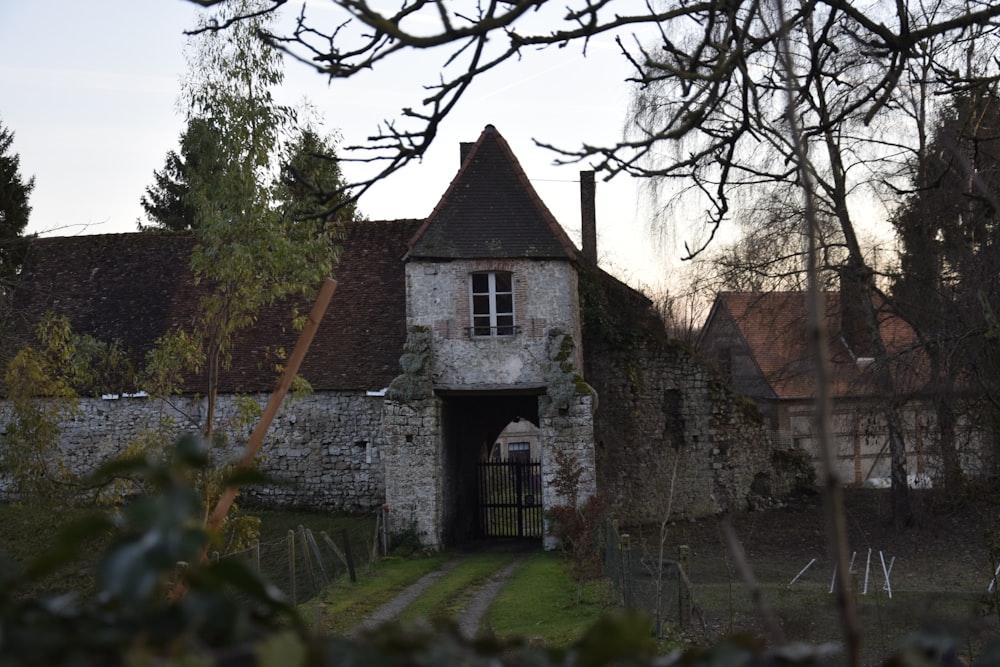 an old building with a tower and a gate