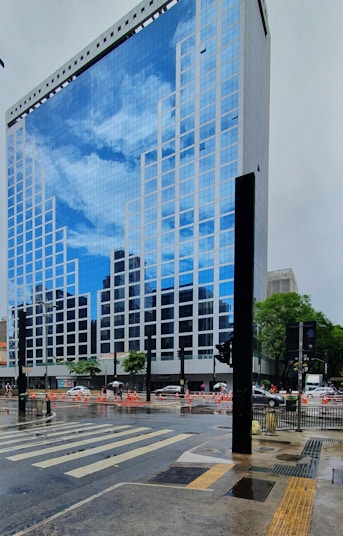 a city street with a very tall building in the background