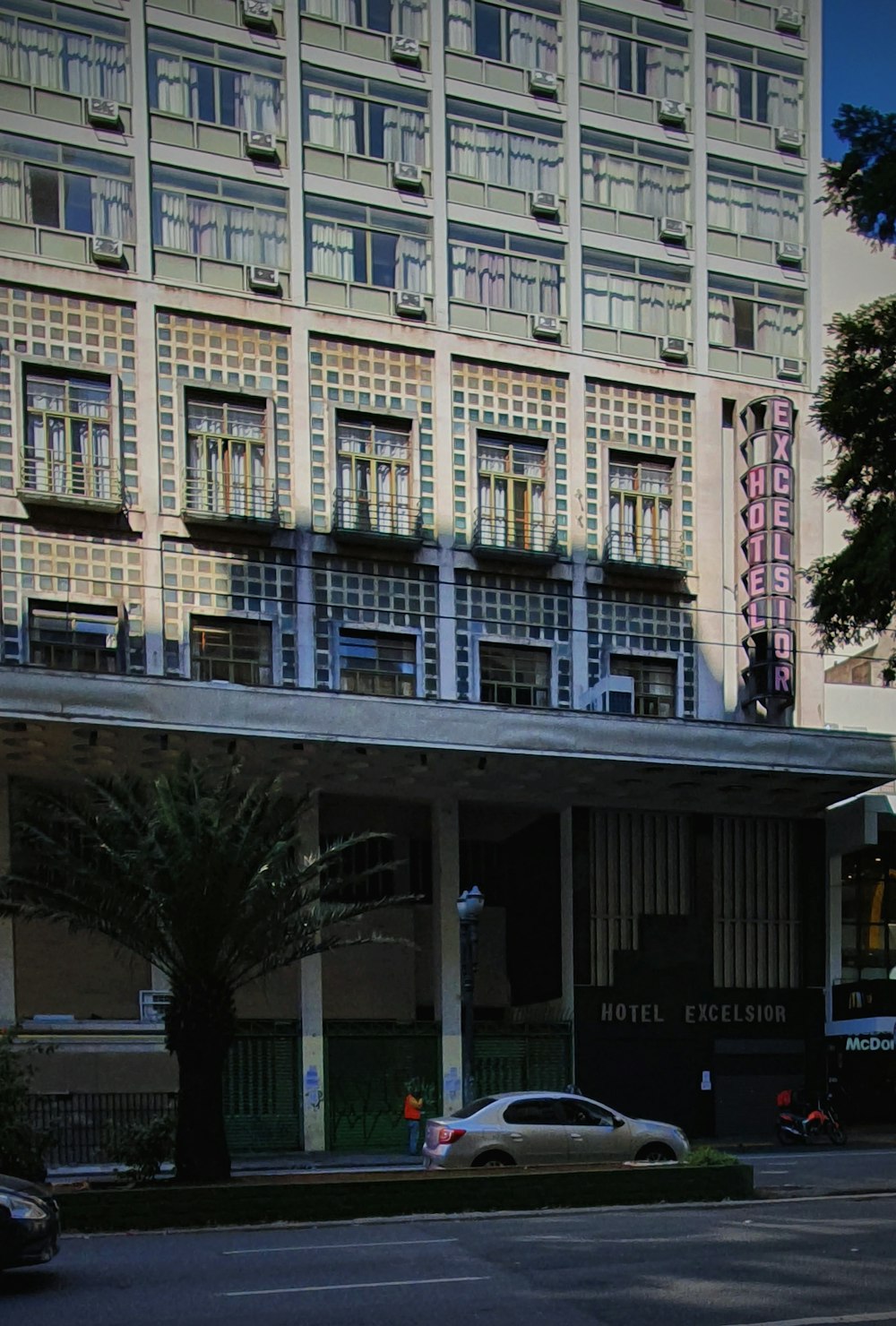 a car is parked in front of a hotel