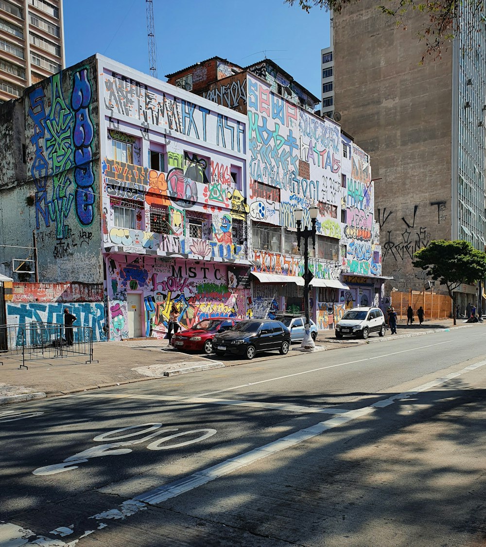 a building covered in graffiti on the side of a street
