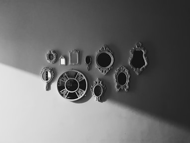 a black and white photo of a wall clock