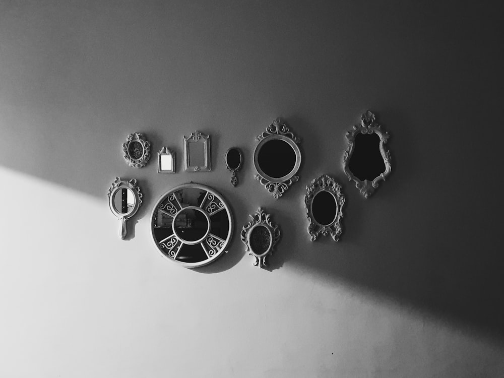 a black and white photo of a wall clock