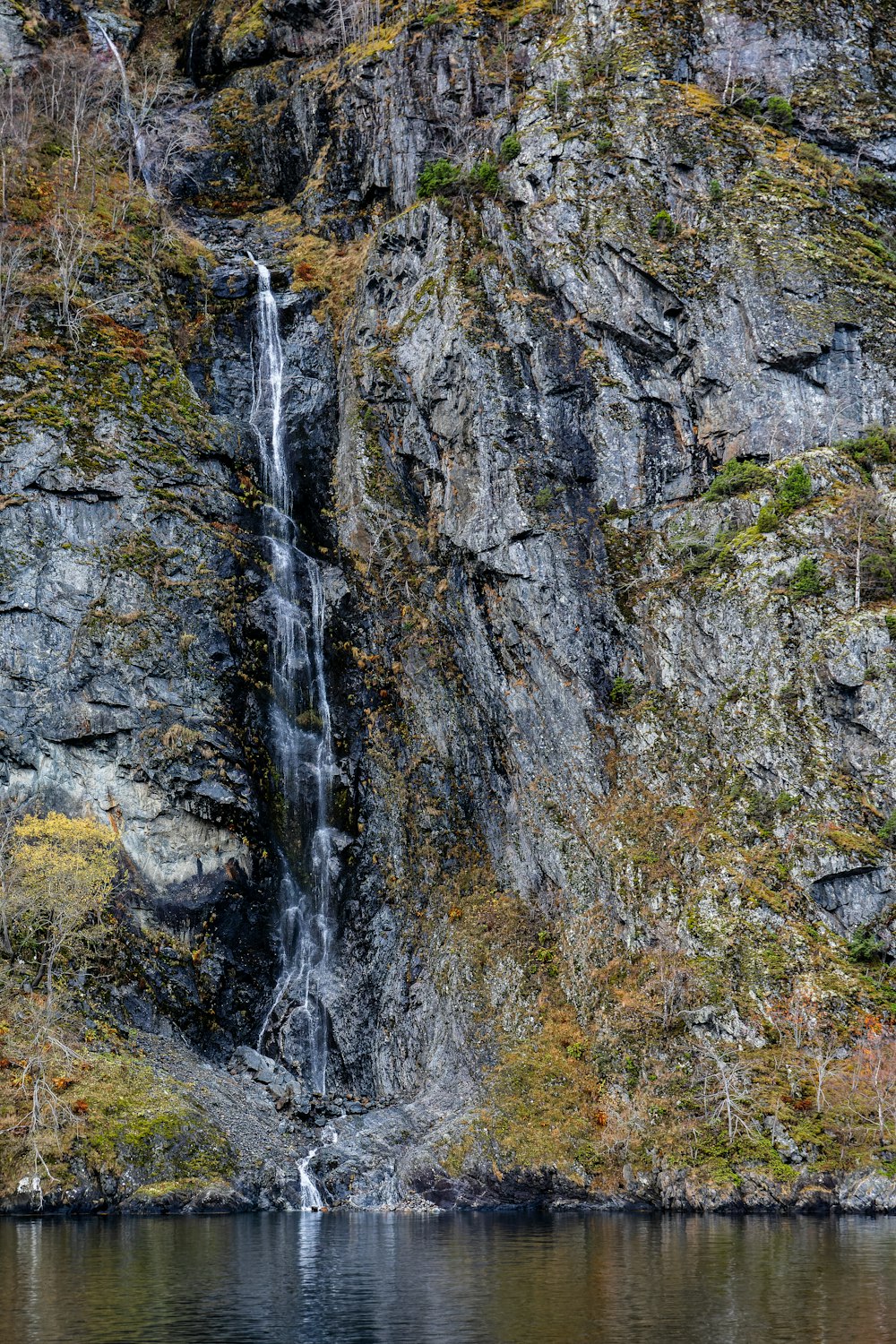 a waterfall in the middle of a rocky cliff