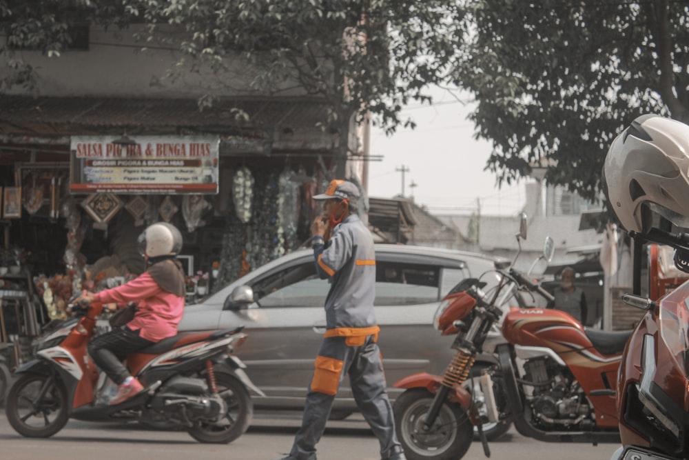 a man on a motorcycle talking on a cell phone