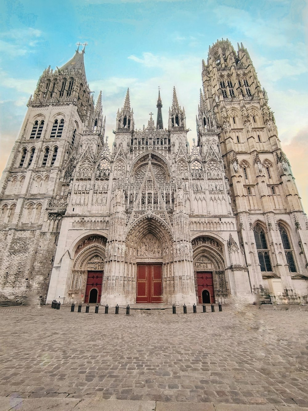 a large cathedral with a red door and two towers