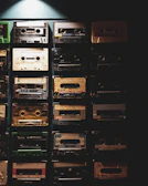 Colorful cassette tapes stacked neatly with a nostalgic 80s background.