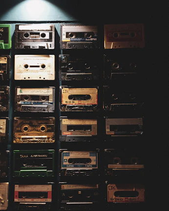Colorful cassette tapes stacked neatly with a nostalgic 80s background.