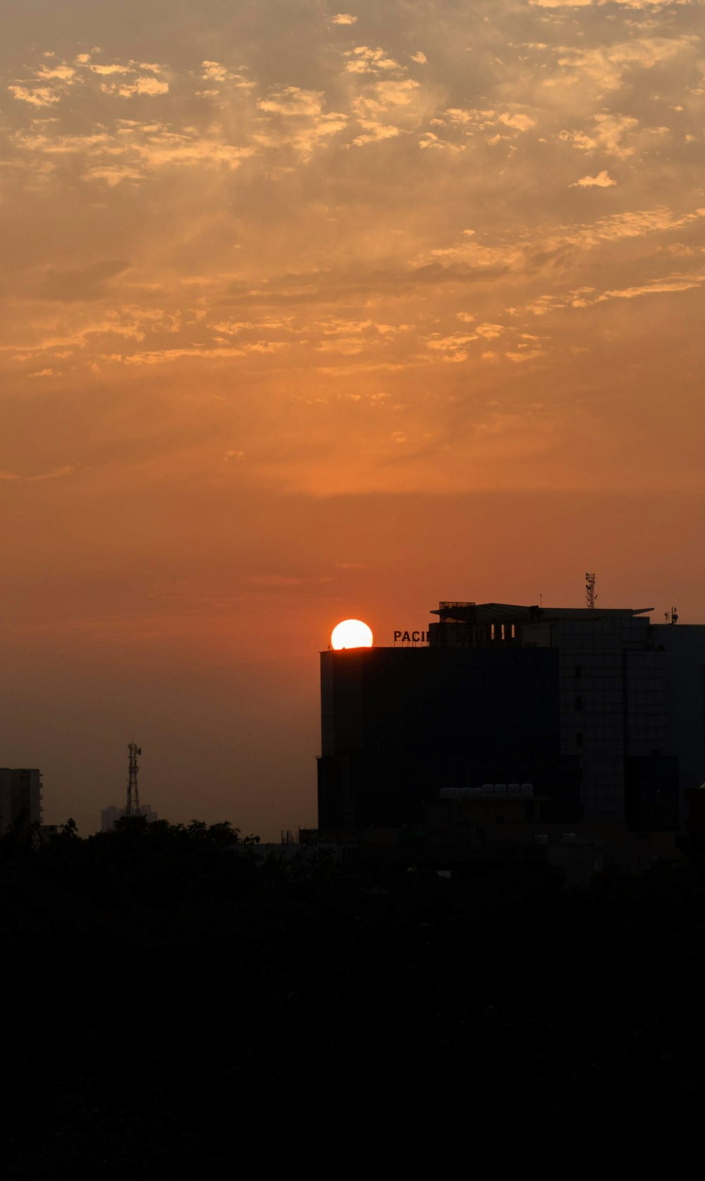 the sun is setting over a city skyline