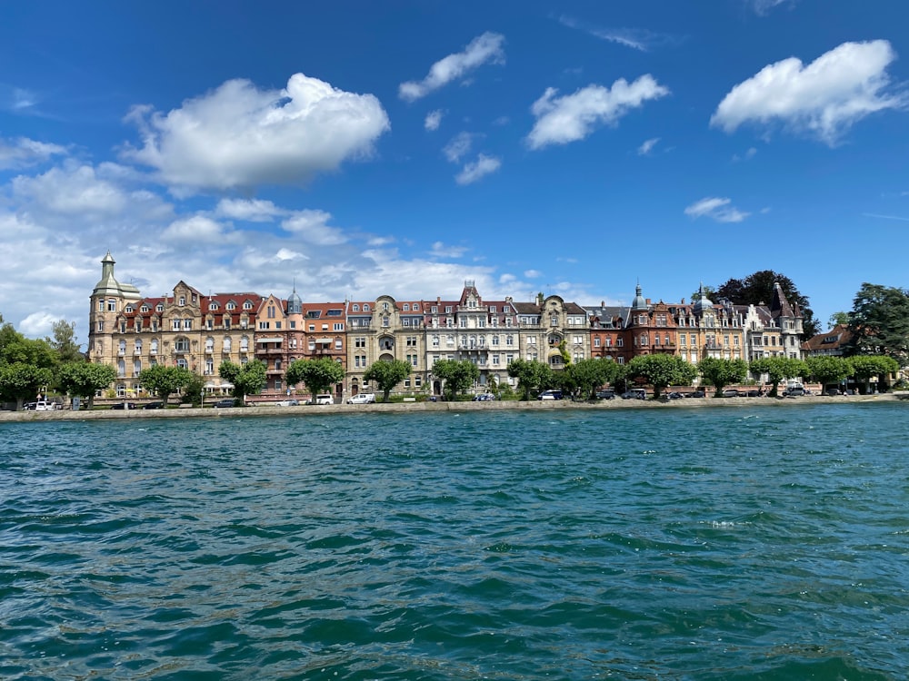 a large building sitting on the side of a lake