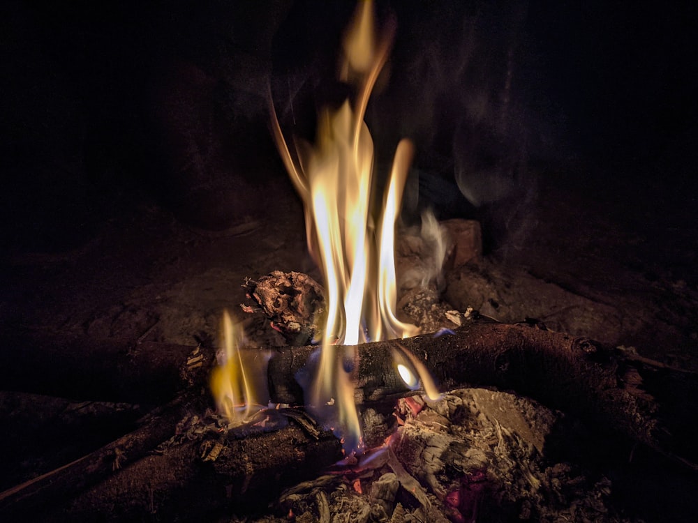 a fire burning in a fireplace with flames coming out of it