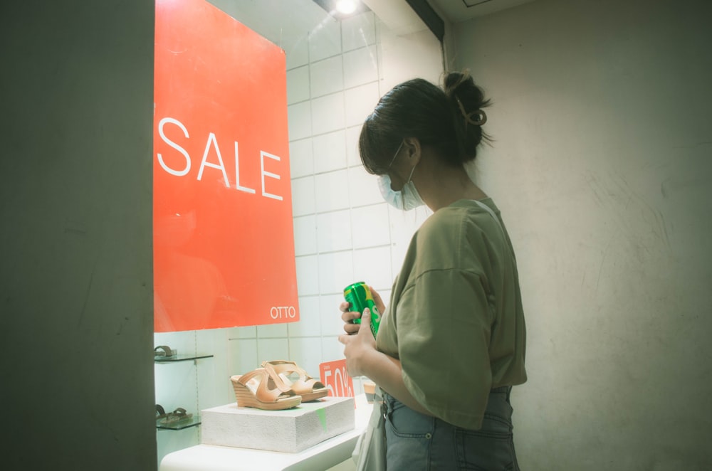 a woman standing in front of a bathroom sink