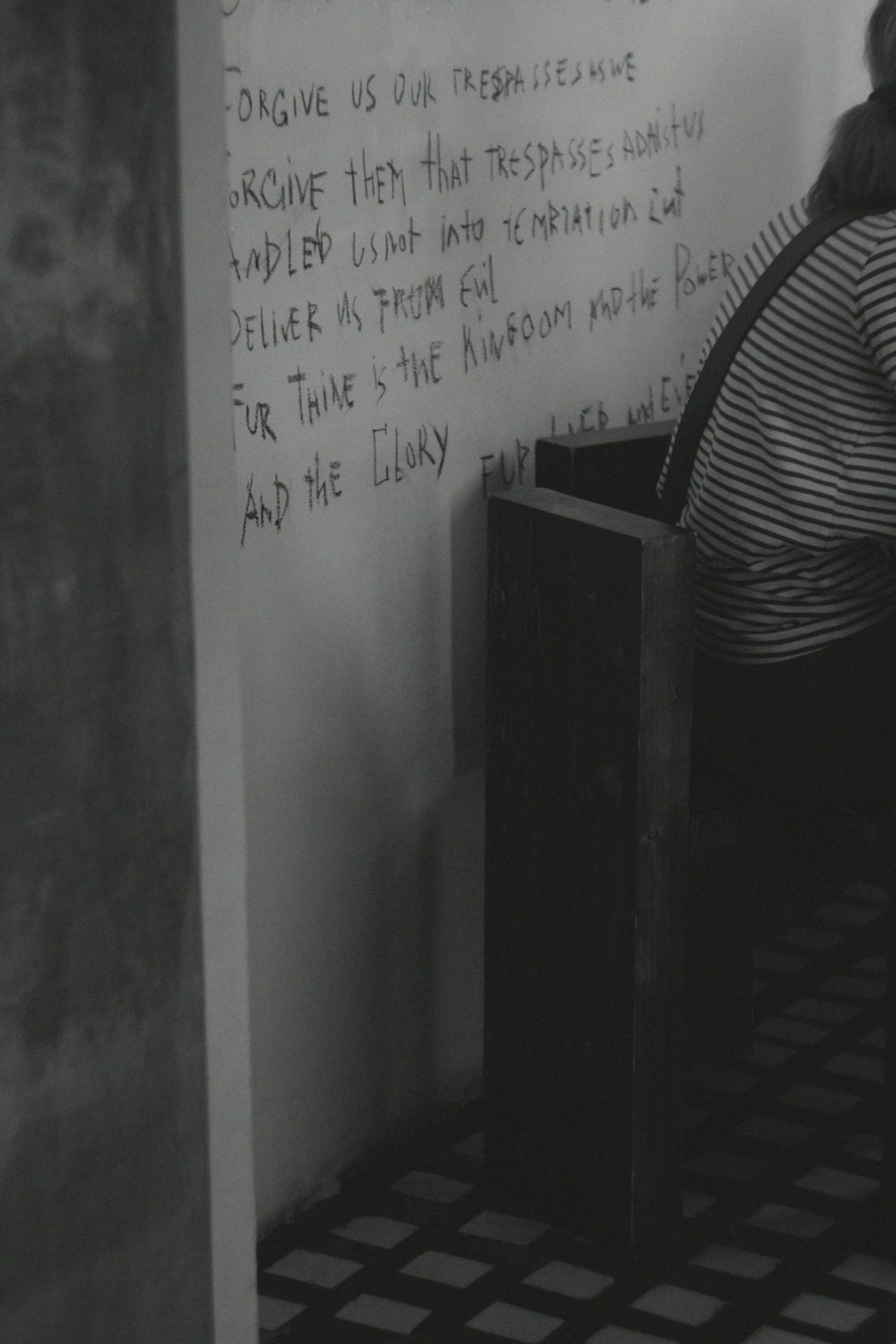 a woman writing on a whiteboard in a room