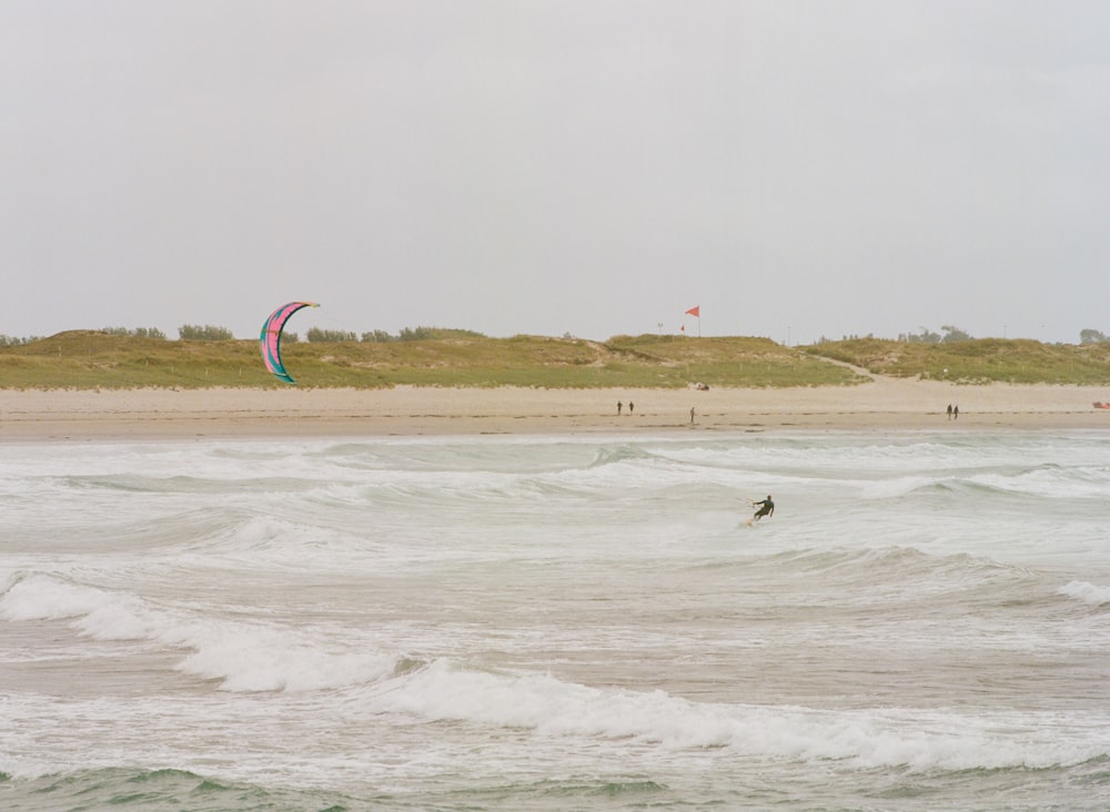 a person riding a surfboard on top of a wave in the ocean