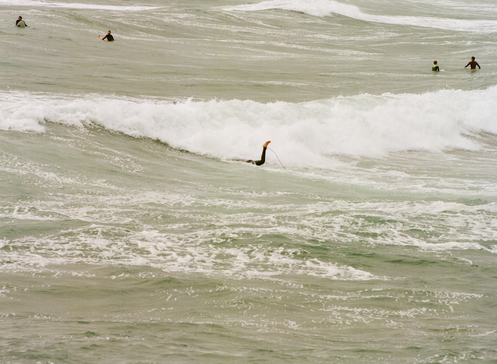 a person riding a surfboard on a wave in the ocean