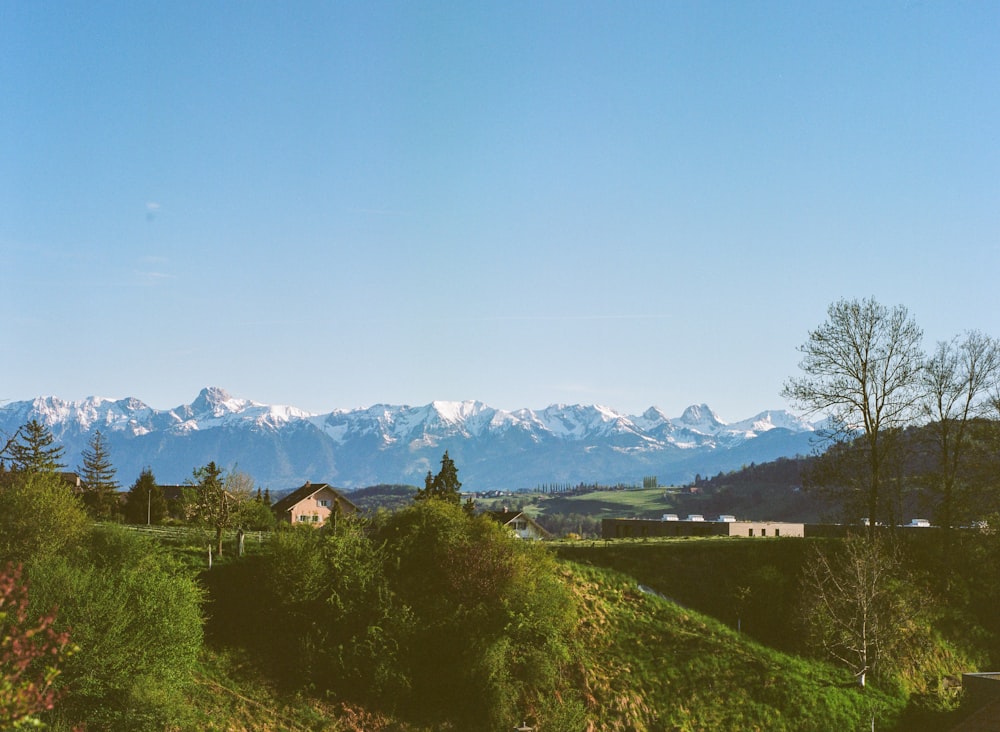 a view of a mountain range with a house in the foreground