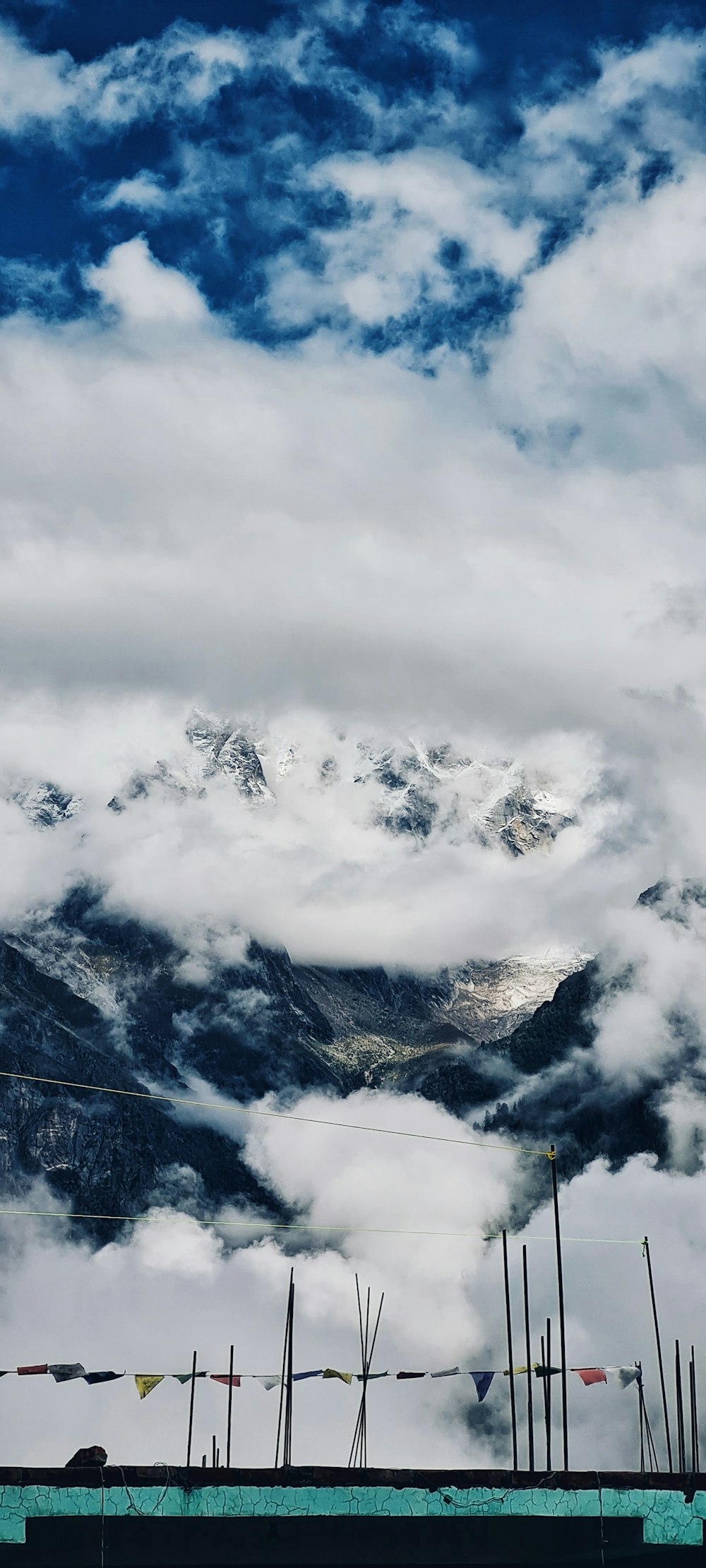 a view of a mountain range with clouds in the foreground