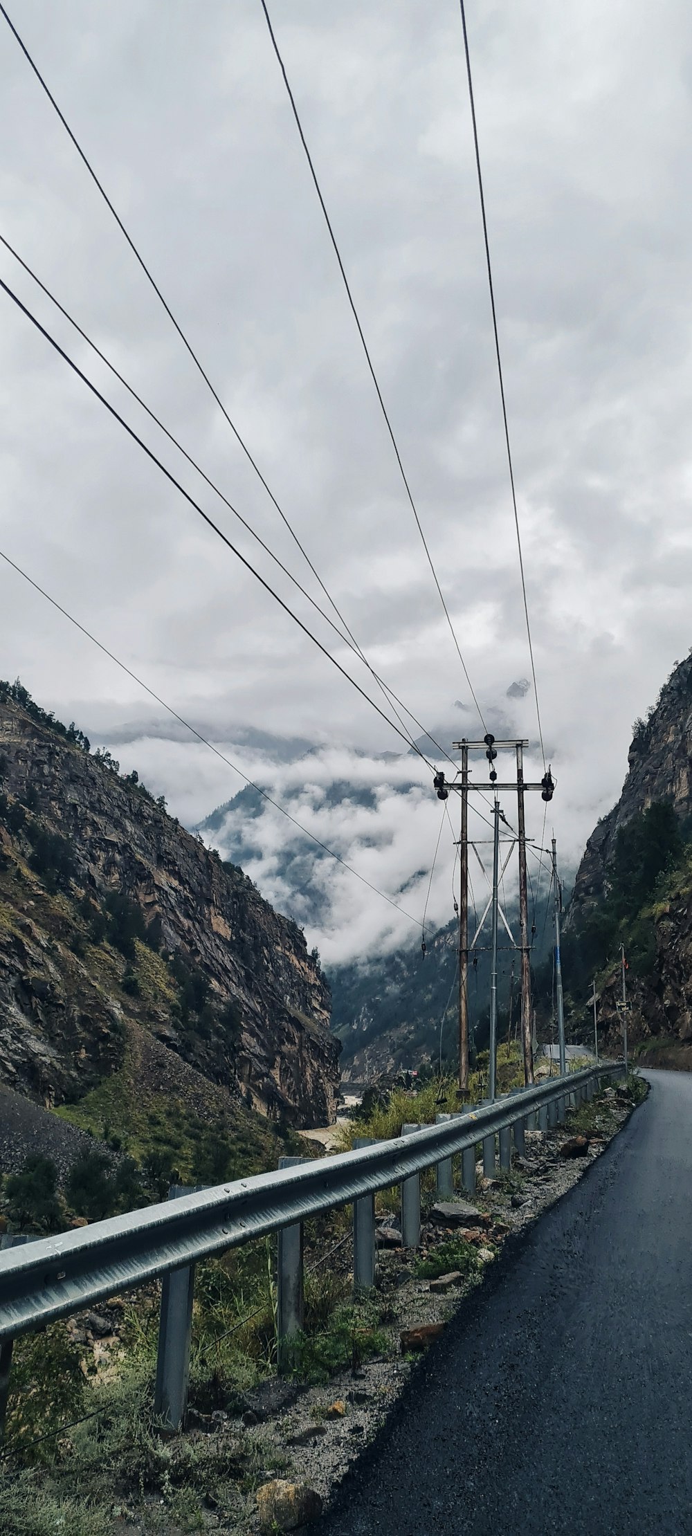 an empty road with power lines above it