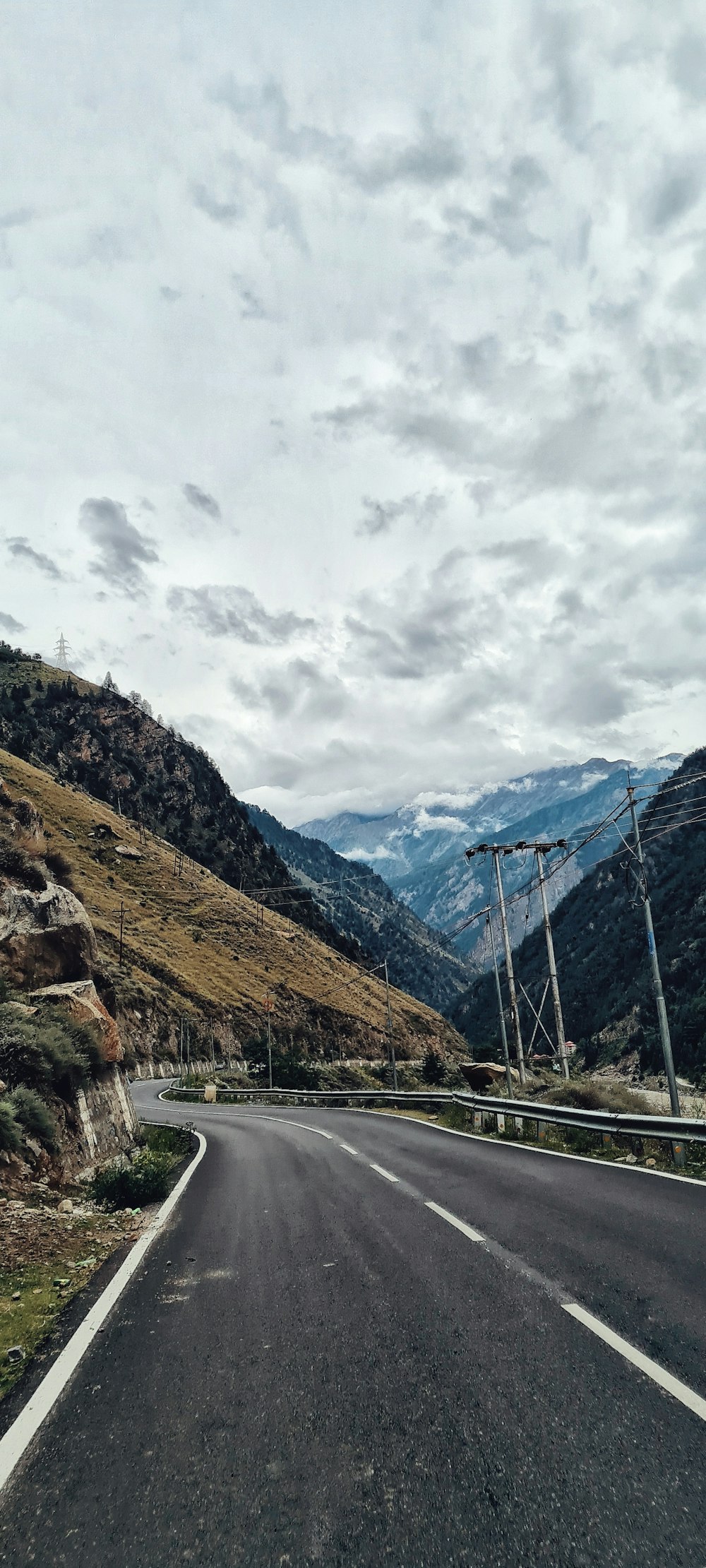 an empty road with mountains in the background