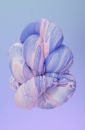 a blue and pink flower on a purple background