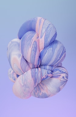 a blue and pink flower on a purple background