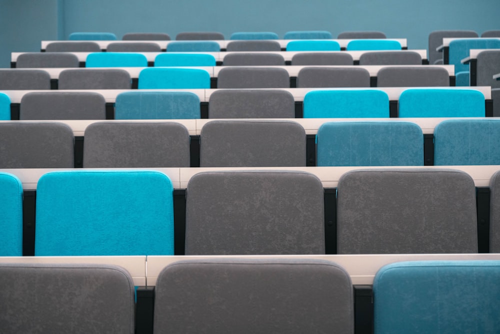 rows of blue and grey chairs in a room