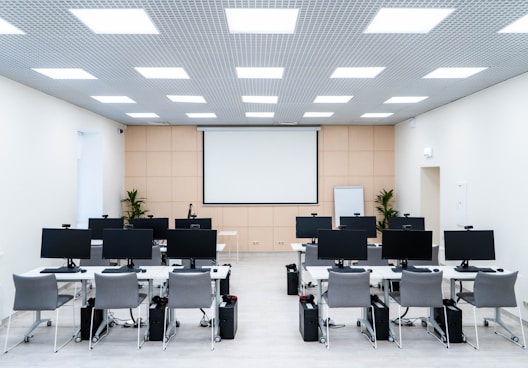 a room filled with lots of desks and computers