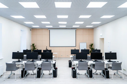 A diverse team of healthcare professionals collaborating in a bright, modern training room.