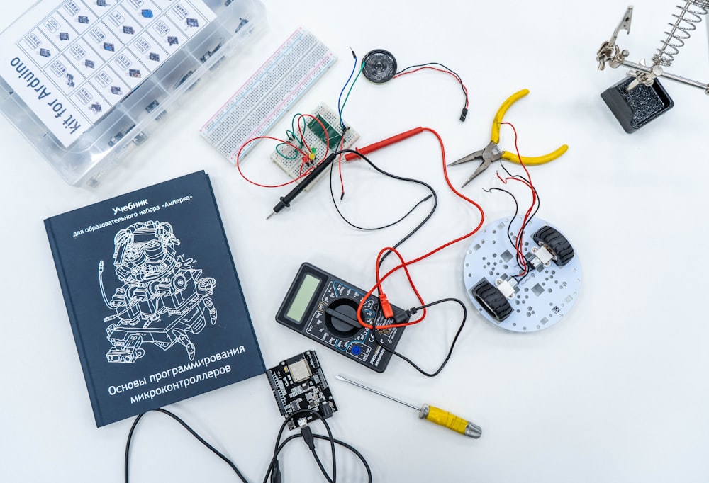 a book and some electronics on a table