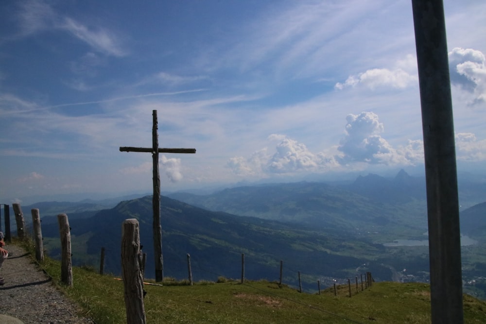 a cross on top of a hill overlooking a valley