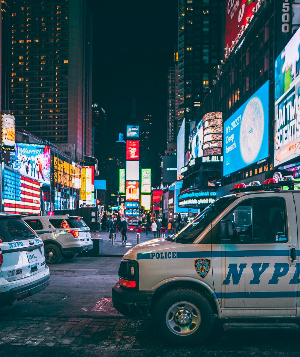 a nypd van parked on the side of a busy street