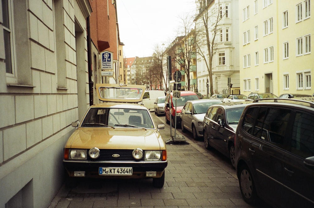 a car parked on the side of a street next to a building