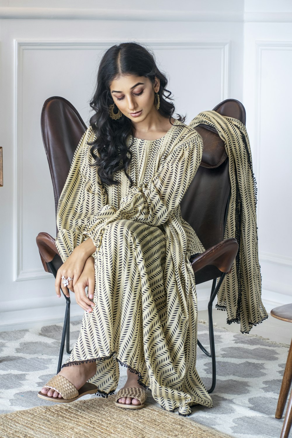 a woman sitting on a chair in a room