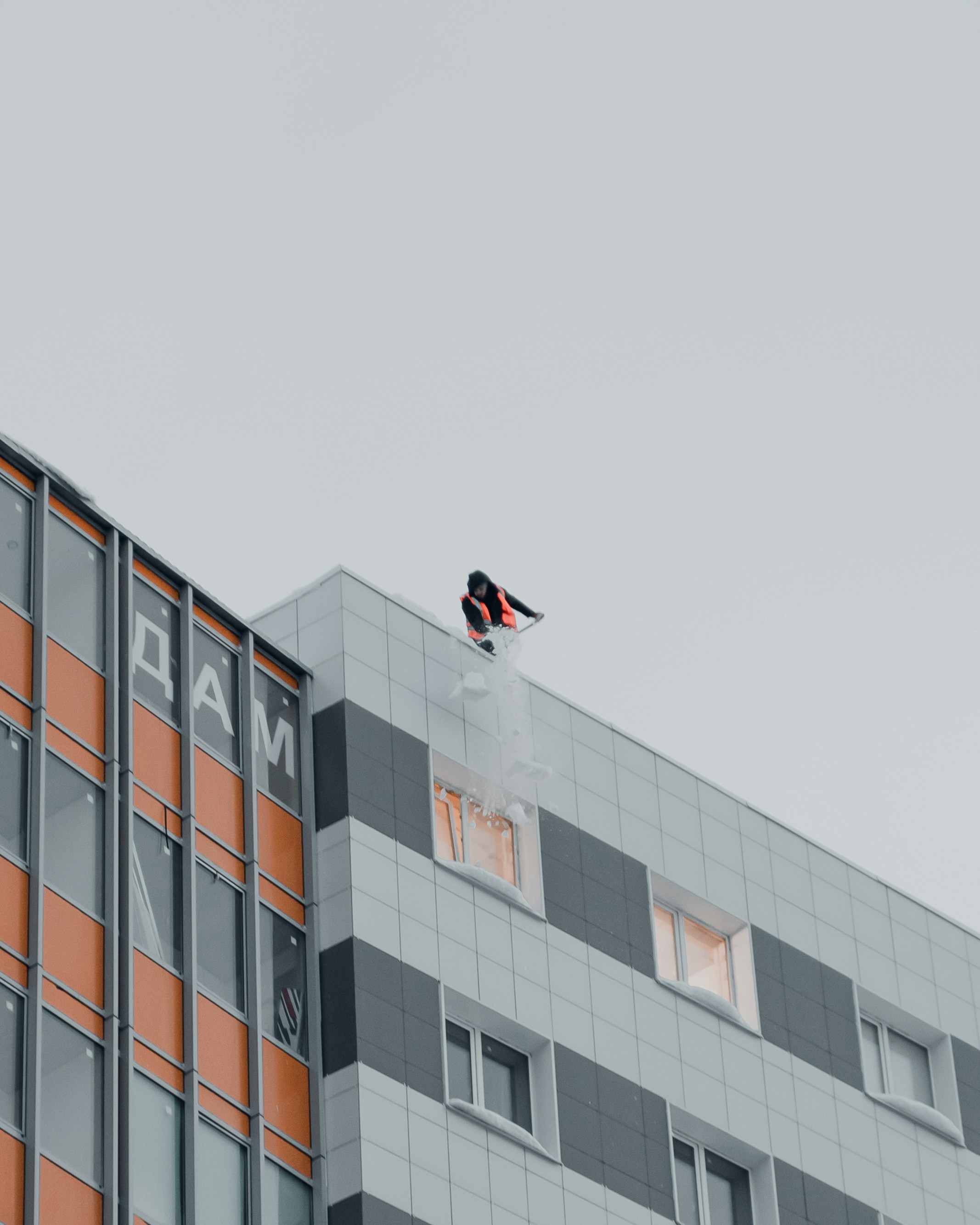 an airplane flying over a building with a sky background
